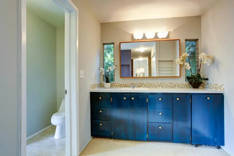 bathroom mirror with blue vanity